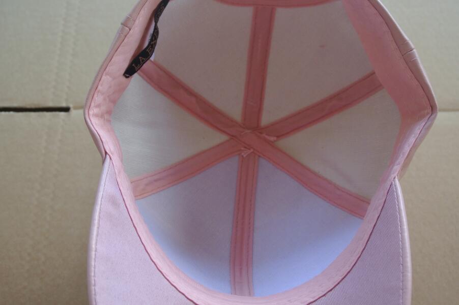leather cap with pom pom