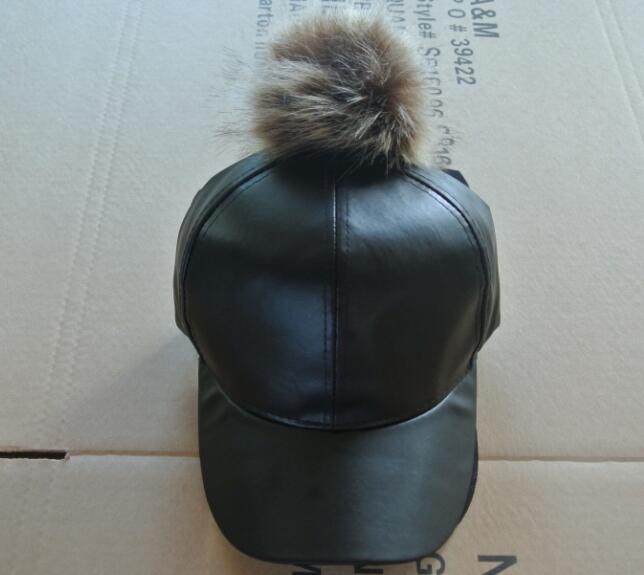leather cap with pompom