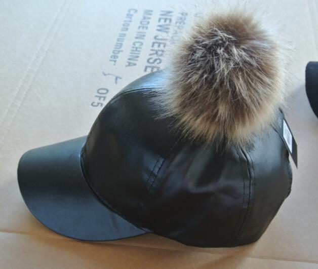 leather cap with pompom